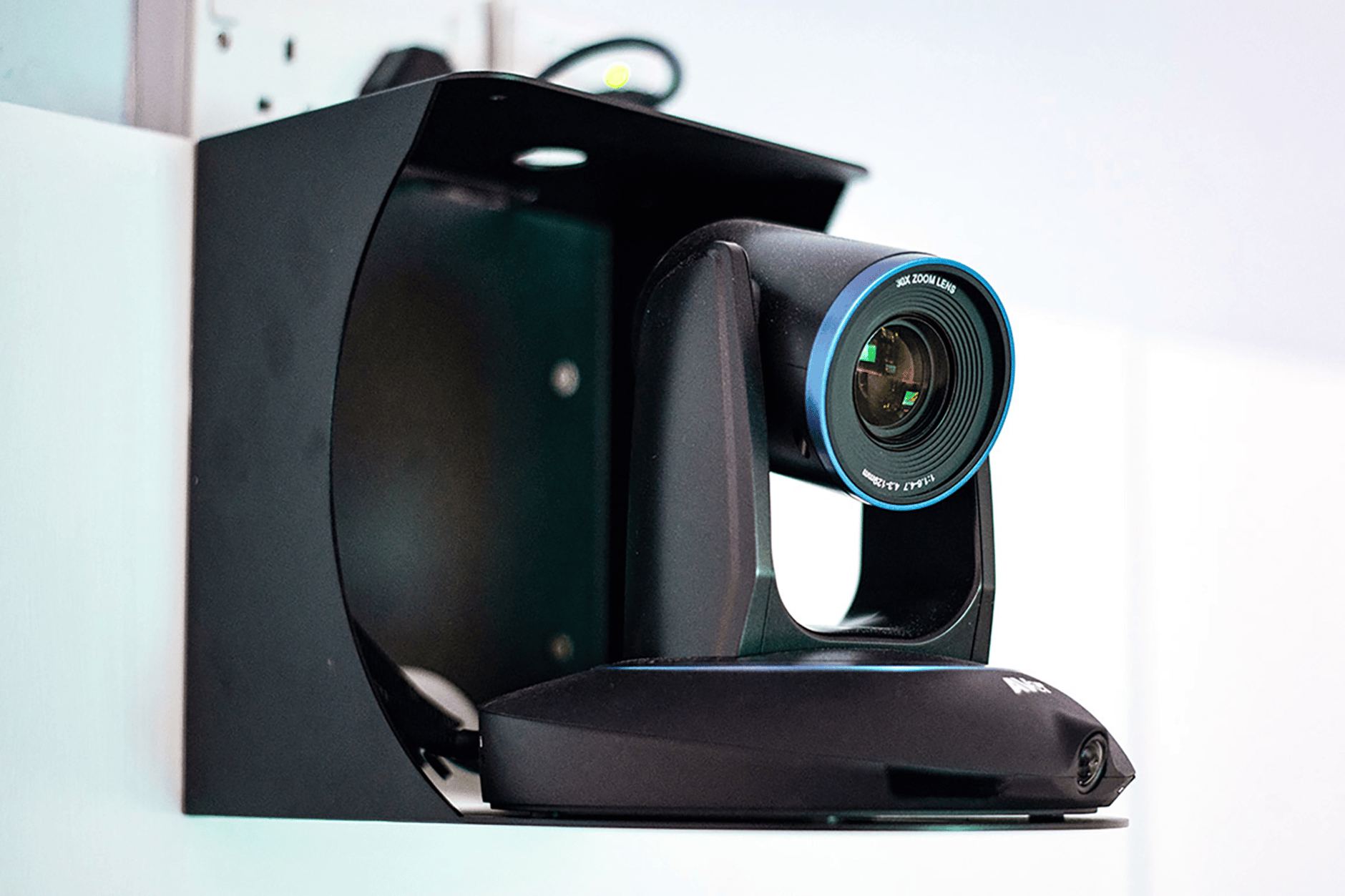 PTZ camera mounted on a wall bracket for tracking by Sennheiser TCC2.