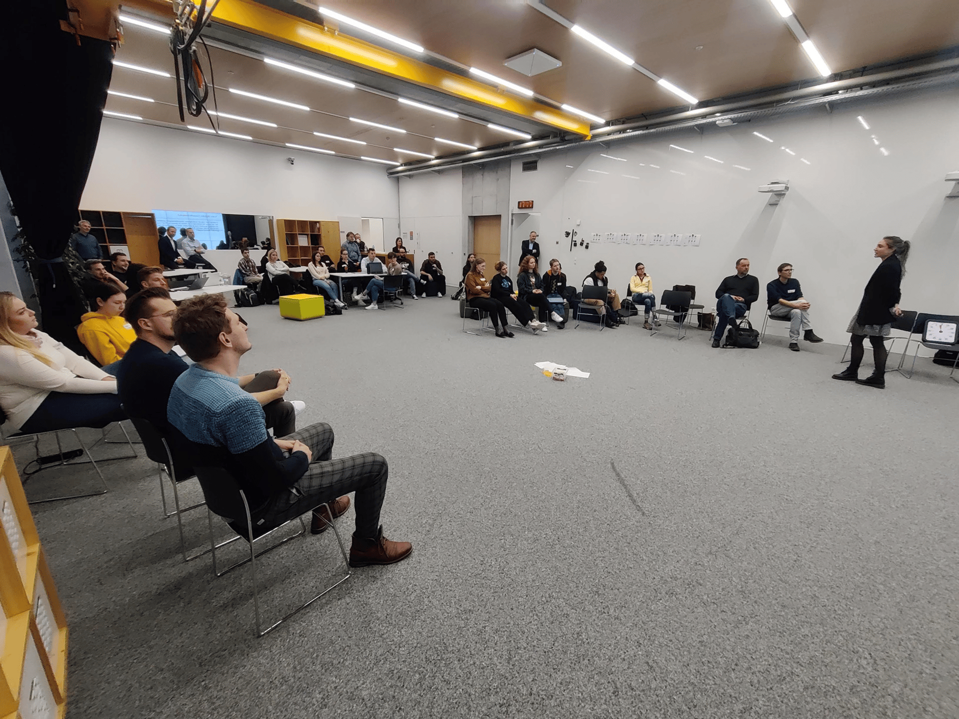People attending a discussion at the University of Applied Science Graubünden media house.