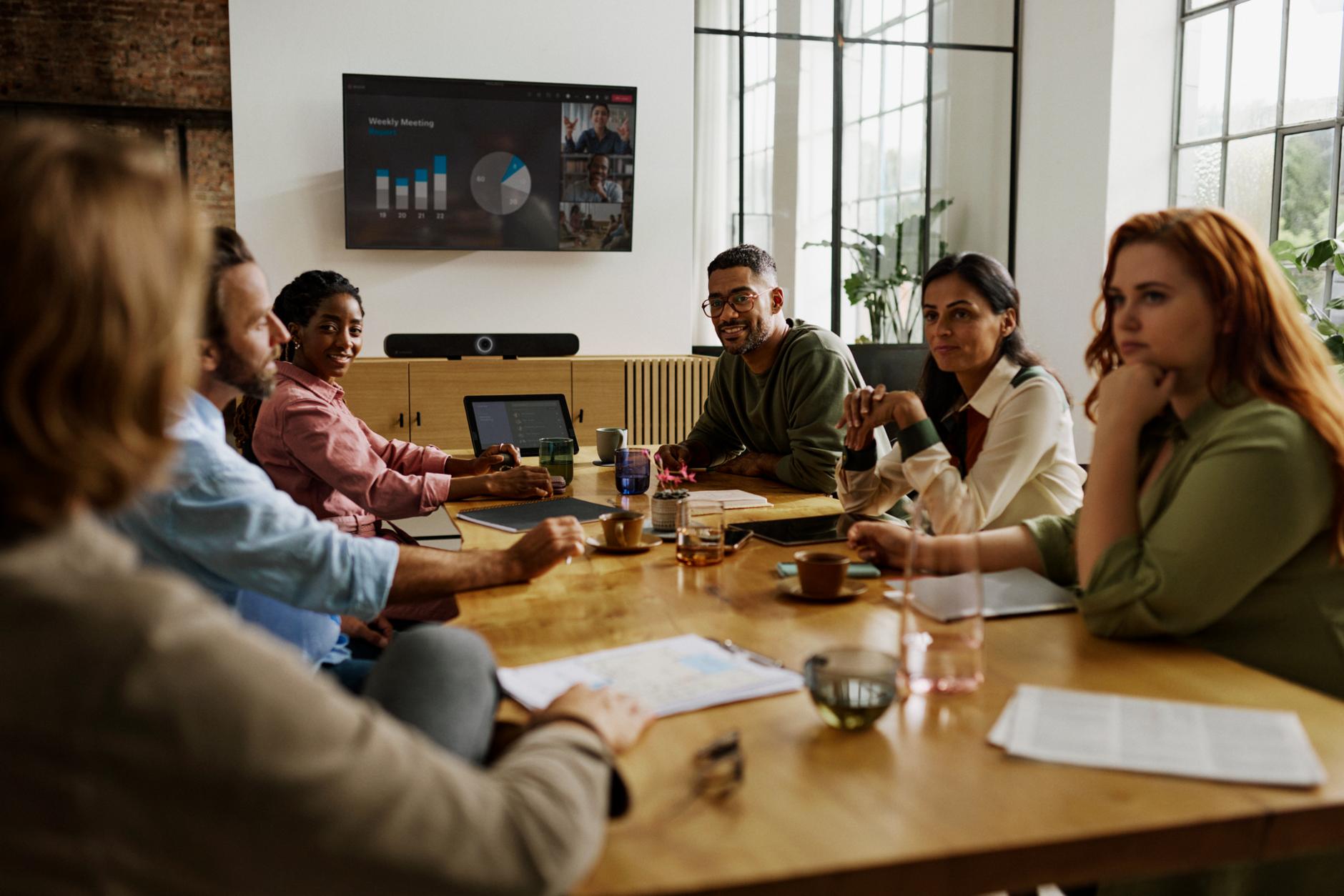 Team meeting in a modern conference room with Sennheiser TeamConnect system.