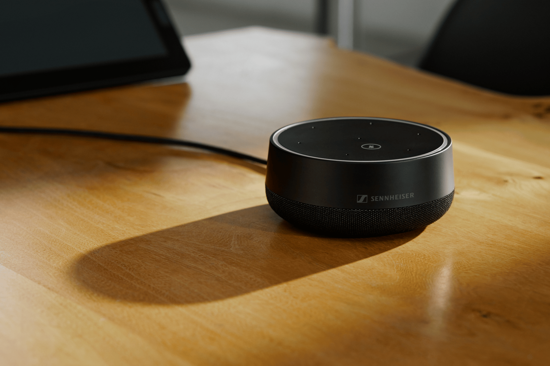Sennheiser state-of-the-art conference speaker on a wooden table.