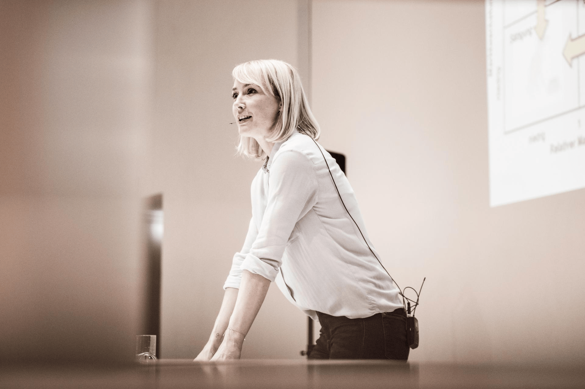 Woman giving a presentation with a headset microphone.