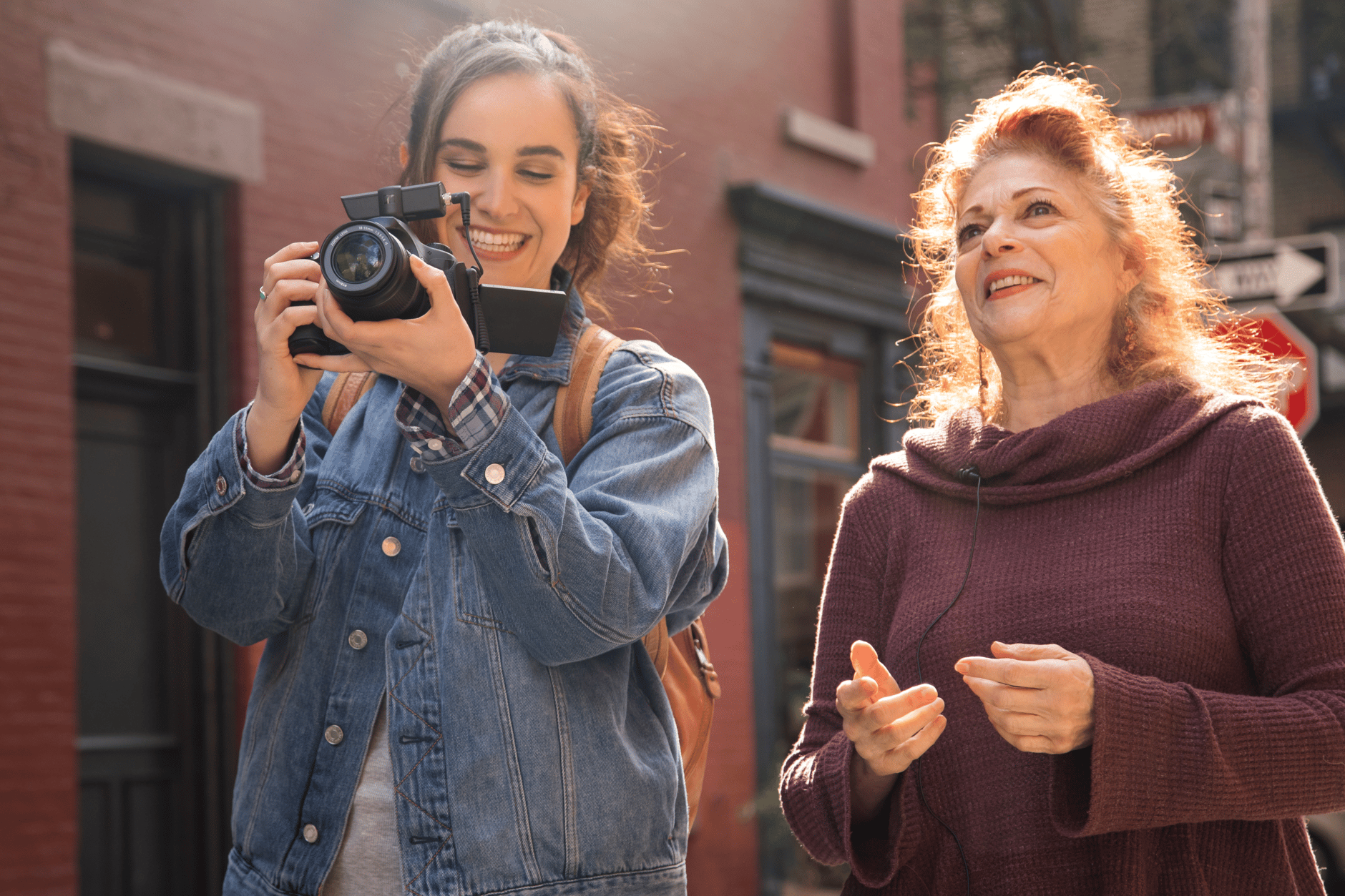 Two women using Sennheiser XS Wireless Digital microphone outdoors.