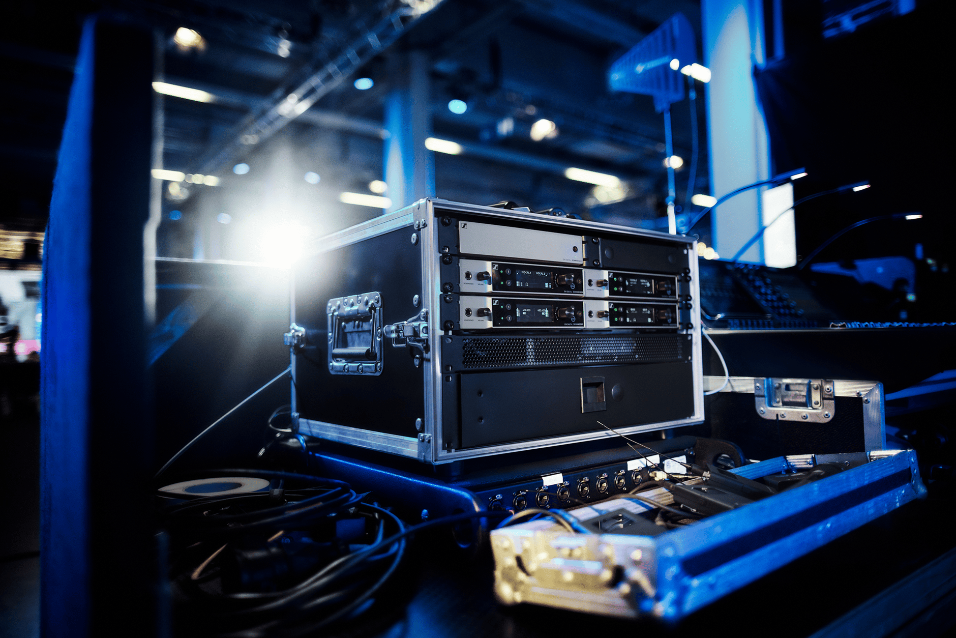 Professional audio equipment setup in a dimly lit studio with blue lighting.