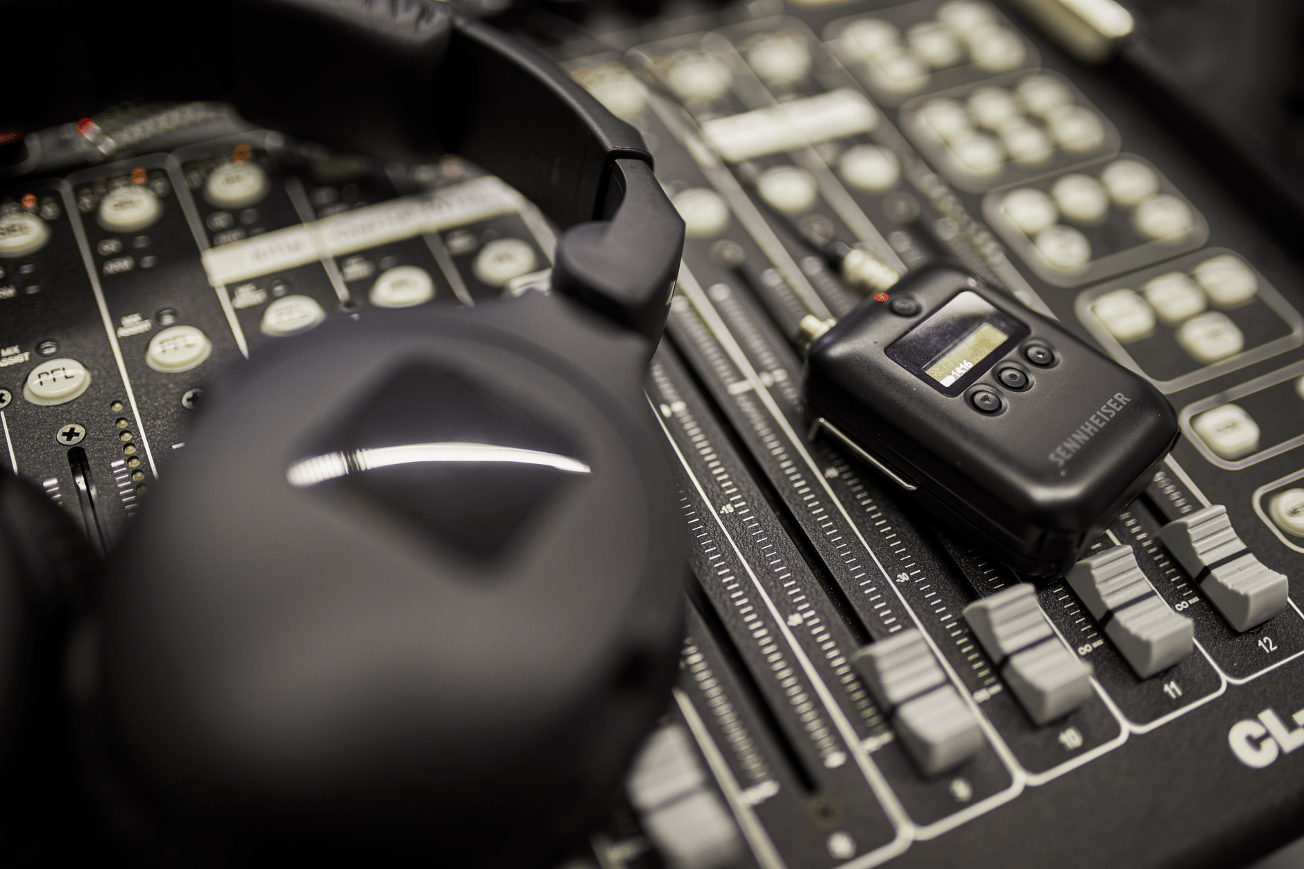 Sennheiser wireless microphone system on audio mixing console.