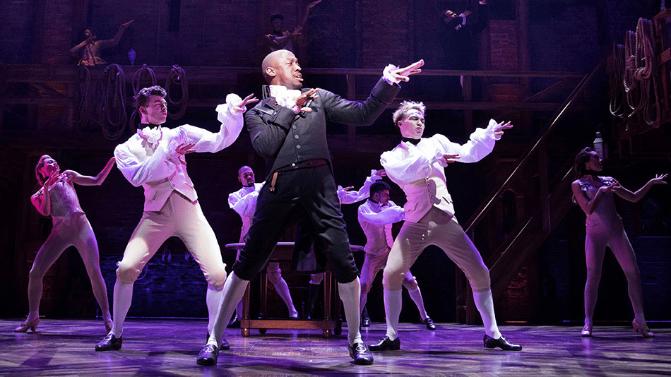 Performers on stage in a dynamic musical theater production.
