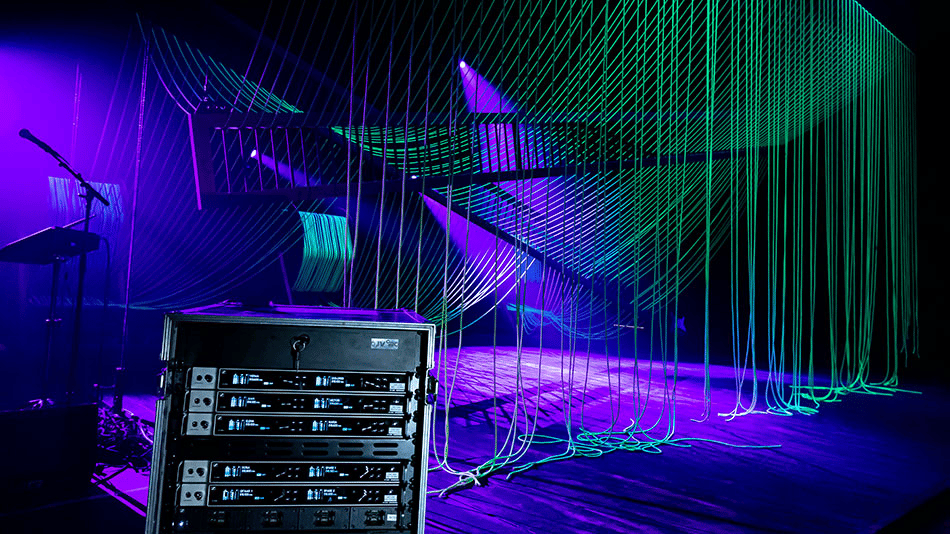 Stage setup with Sennheiser audio equipment and colorful lighting at Het National Theater.