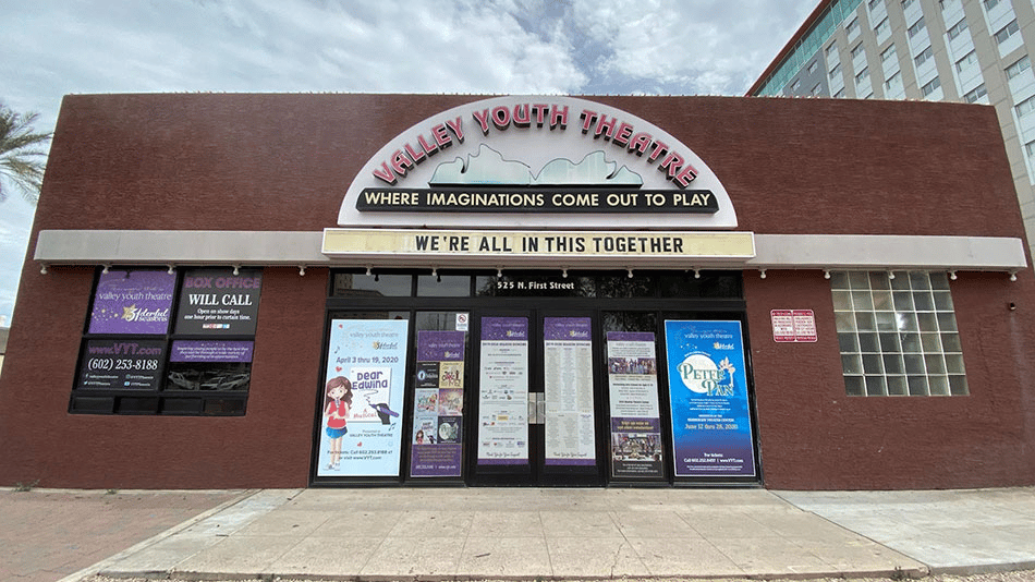 Valley Youth Theatre building with posters and marquee reading "We're All In This Together"