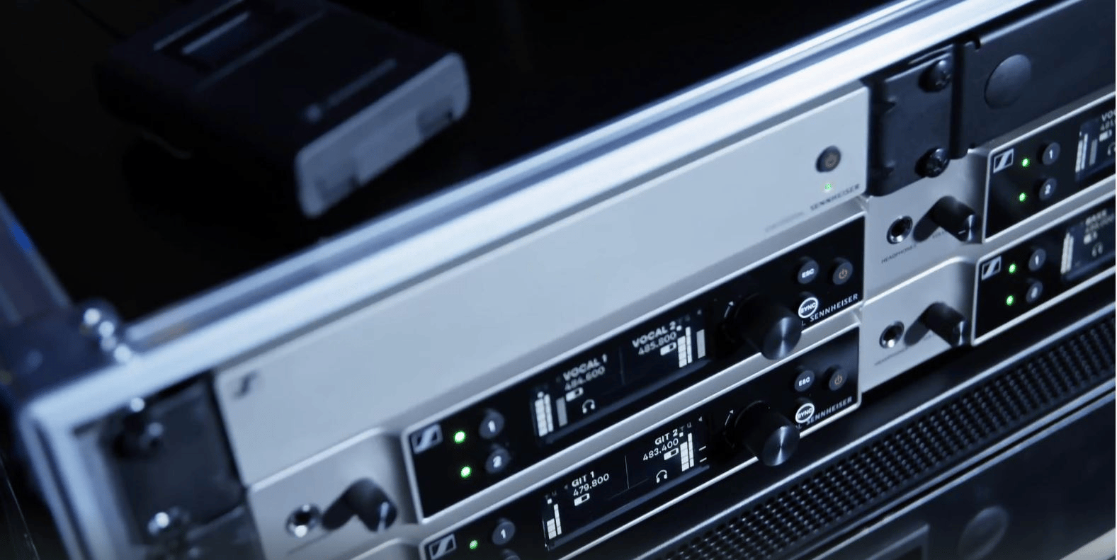Sennheiser wireless microphone system equipment in a rack.