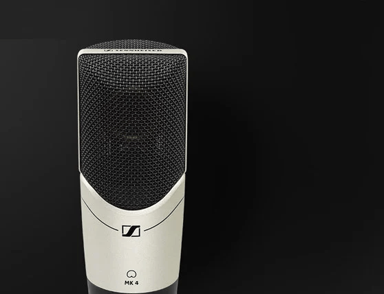 Sennheiser MK 4 condenser microphone with black grille and silver body against a black background.