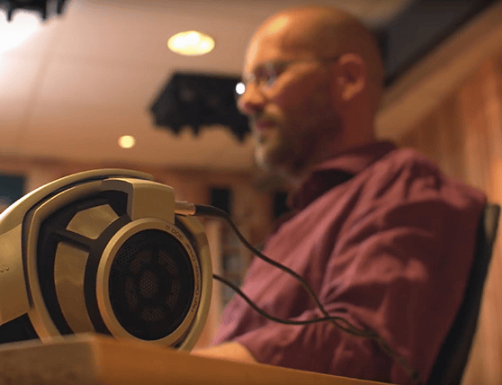 Man wearing headphones in a recording studio.