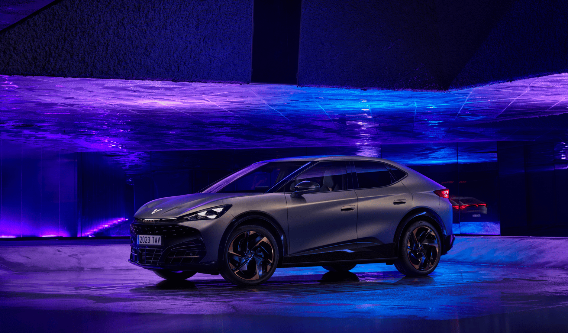 Sleek black SUV with futuristic lighting in a modern setting.