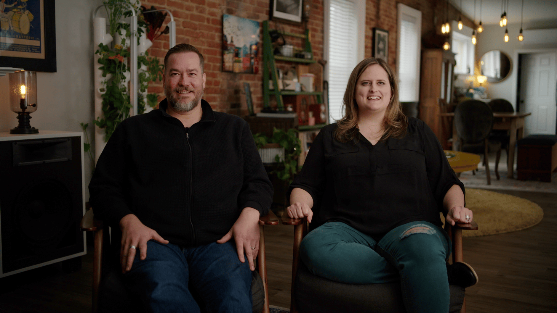 Two people sitting in a cozy, well-decorated living room.