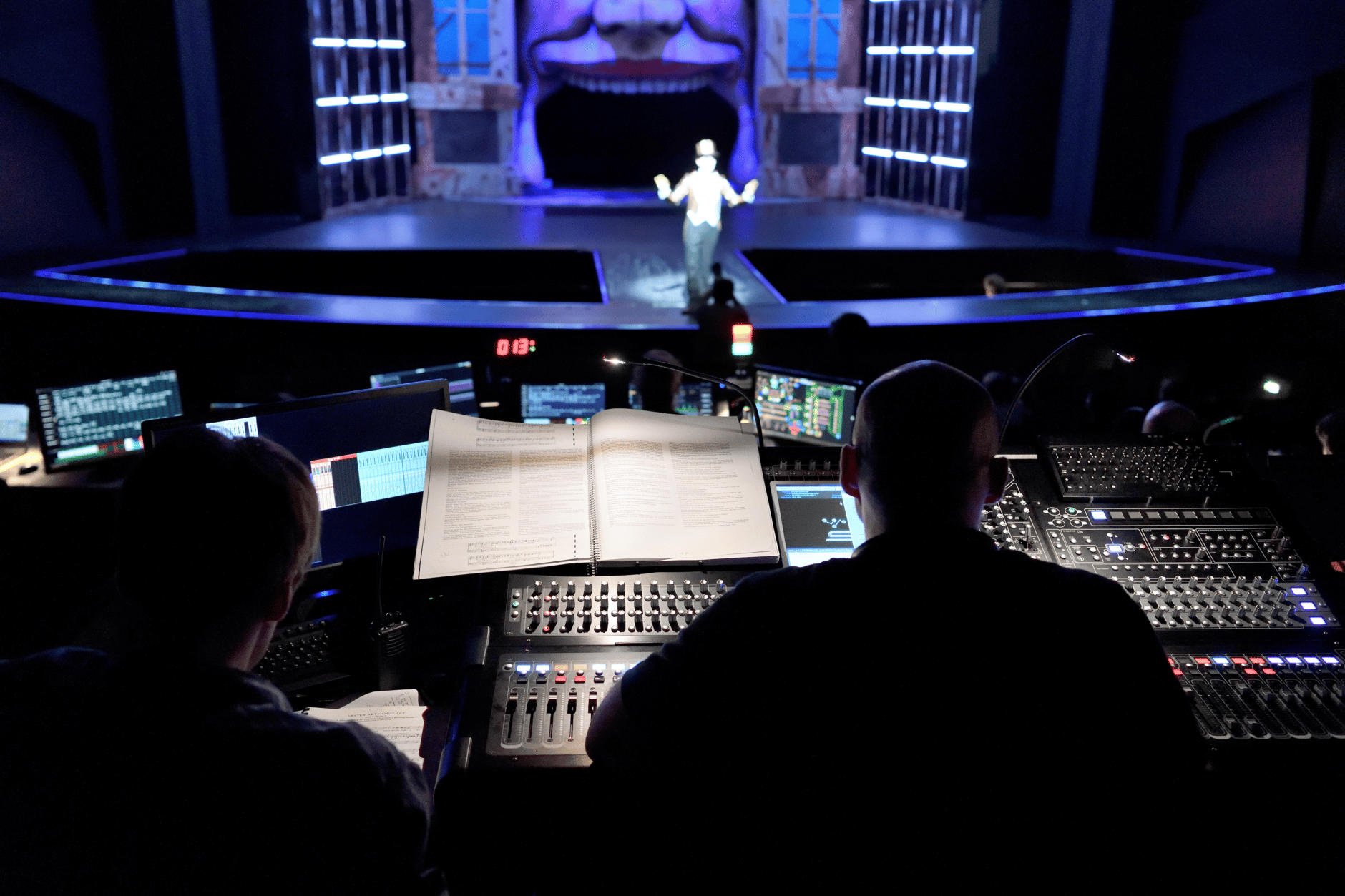 Theatre sound engineers operating audio equipment during a live performance.