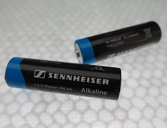Sennheiser AA alkaline batteries on a textured surface