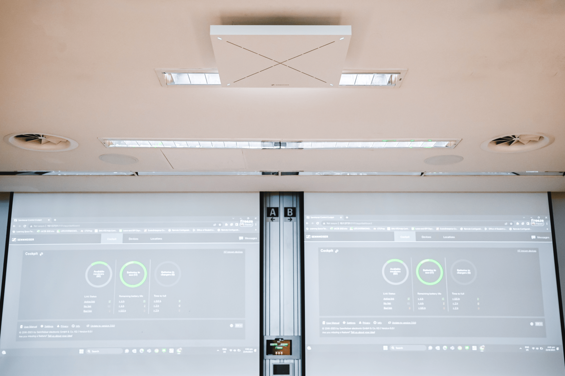 Ceiling-mounted Sennheiser TeamConnect Ceiling 2 microphone in a modern conference room.