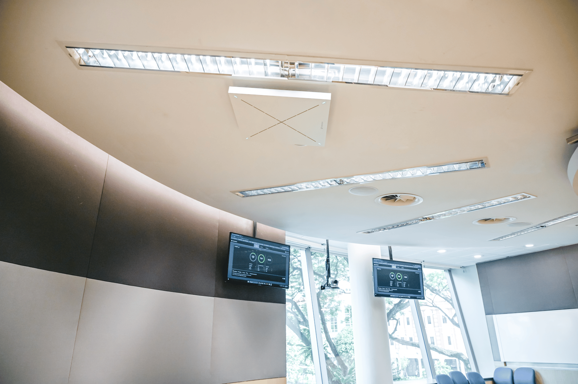 Ceiling-mounted Sennheiser TeamConnect Ceiling 2 microphone in a modern conference room.