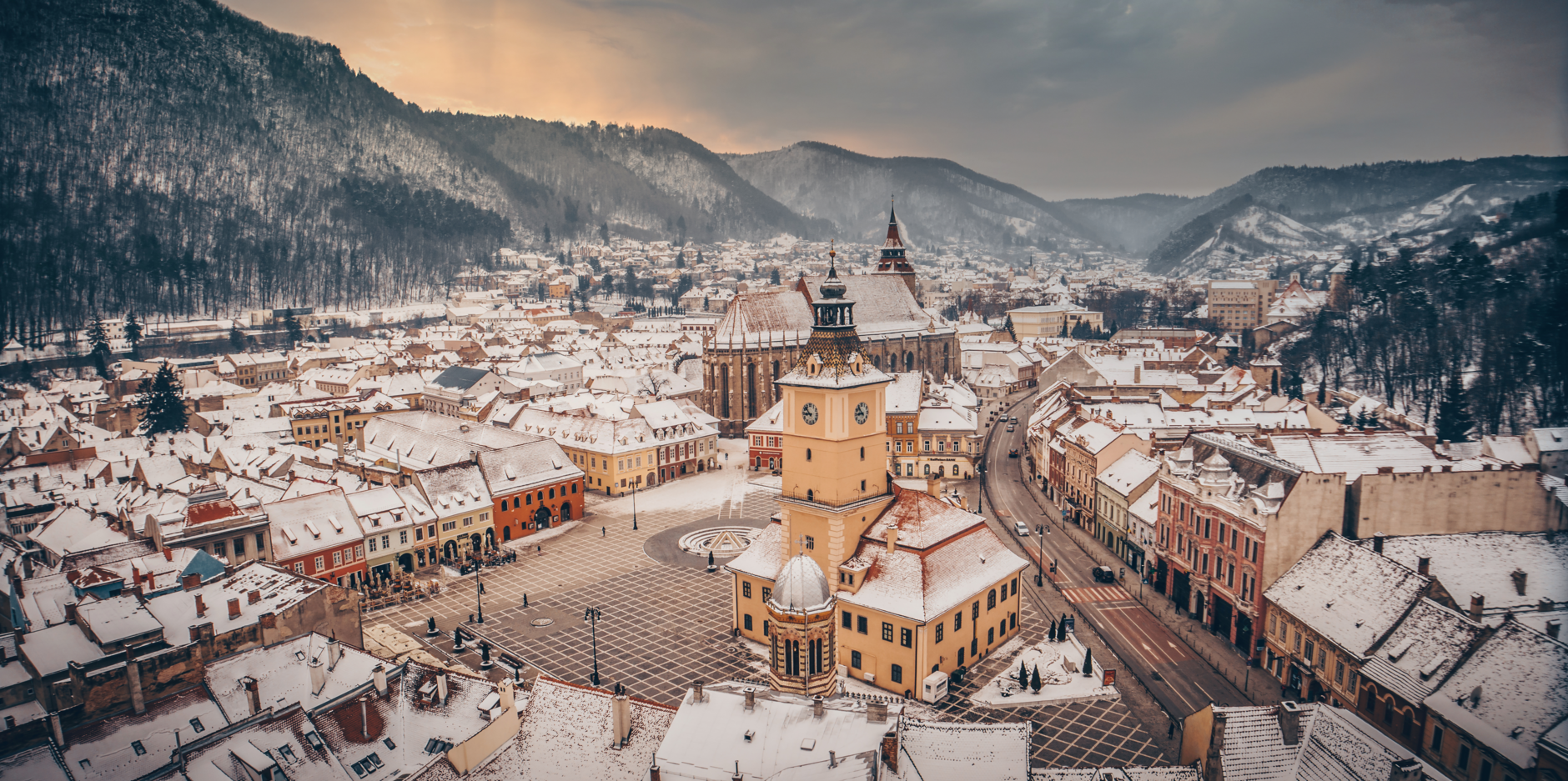 View over the Town Brasov in Romania, which is located in the middle of hills, in Winter