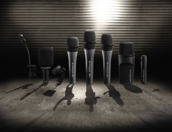 Sennheiser Evolution Series microphones displayed on a concrete floor with a metallic background.