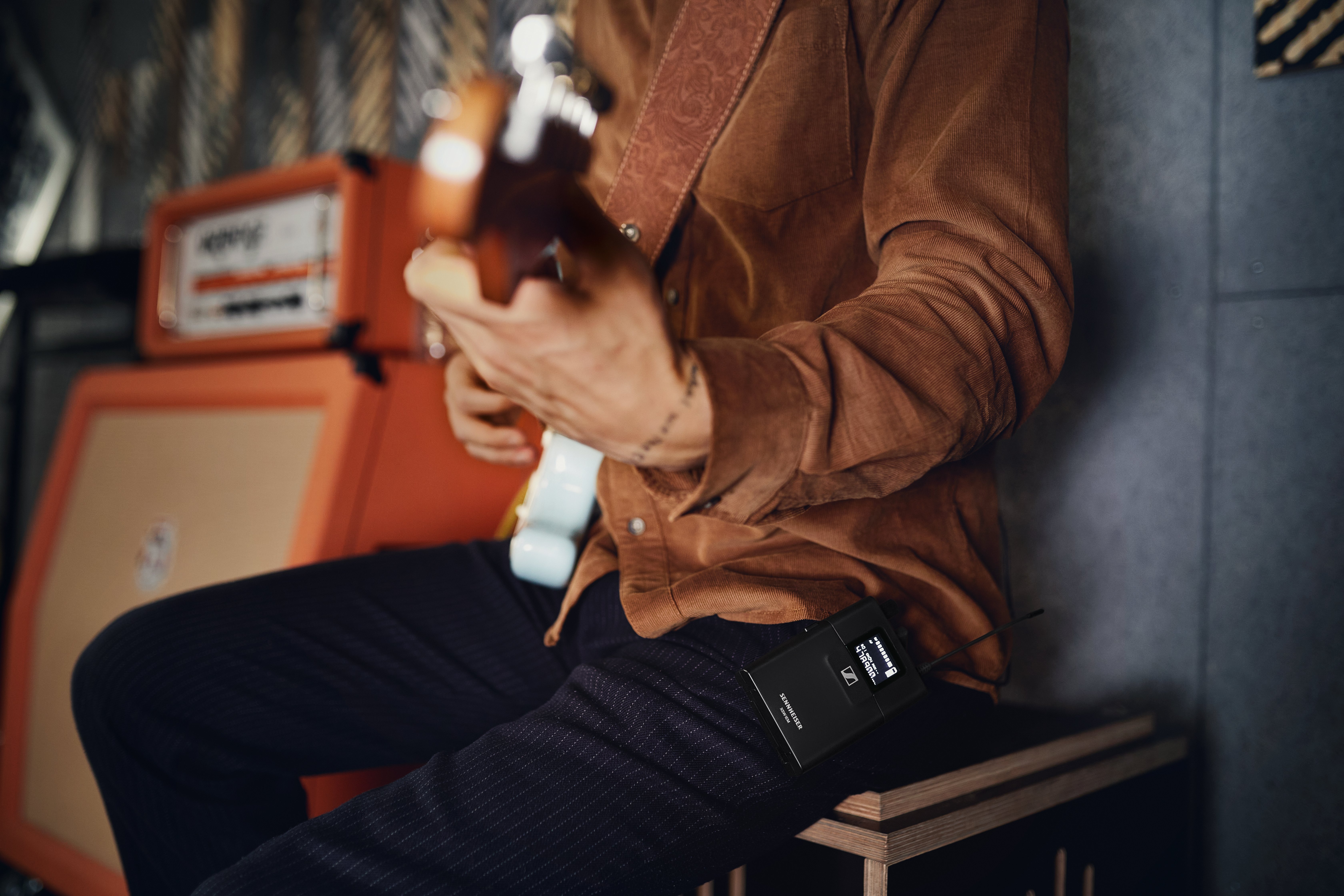Musician using Sennheiser XSW IEM system while playing guitar