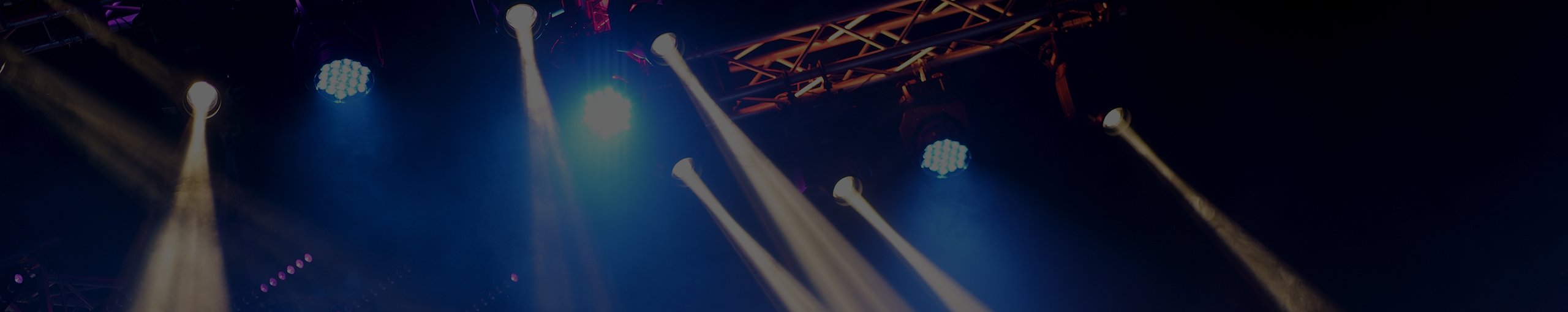 Stage lights and spotlights at a concert.